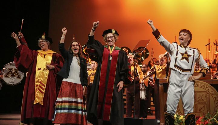 Chair Mayeron, Lt. Governor Flanagan, and President Cunningham celebrate with the Minnesota Marching Band as the University formally installed its 18th president